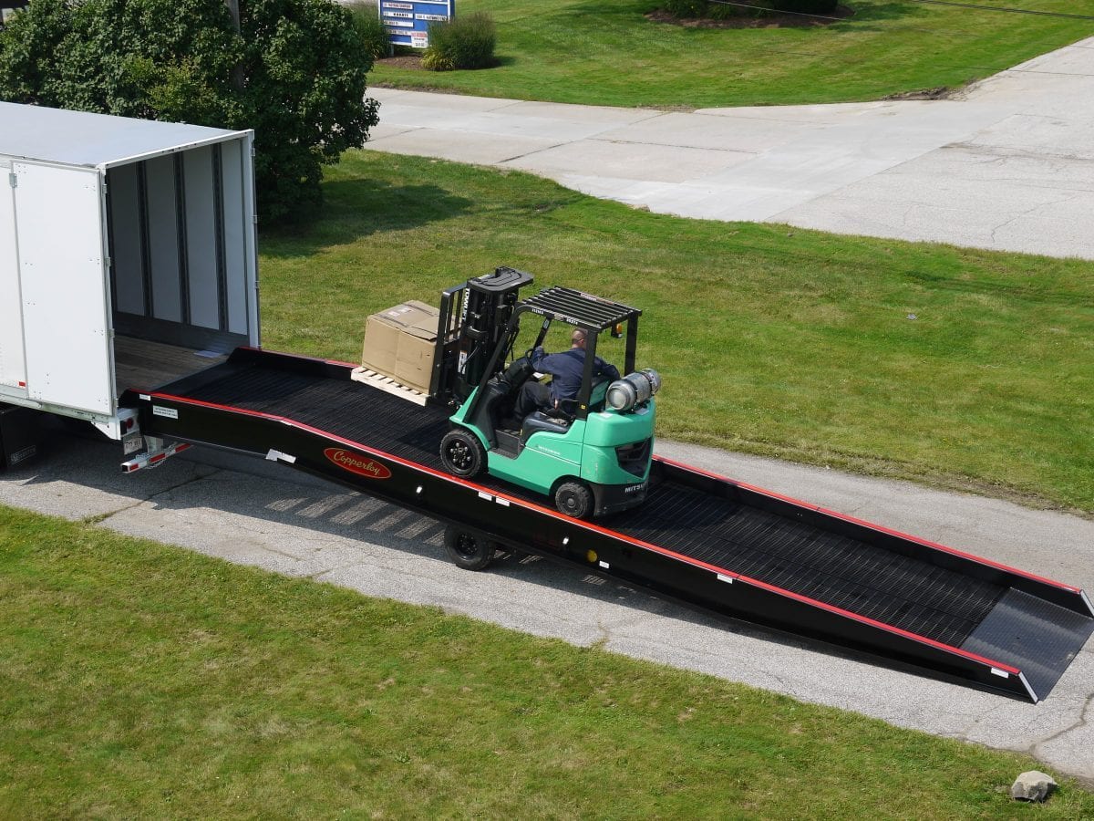 A forklift traveling on one of Copperloy's forklift ramps.